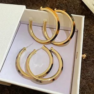 Vintage tortoiseshell acetate C-shaped hoop earrings with gold metal inner lining