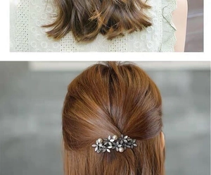 Detail of dark grey flower hair clip with pearls and rhinestones on hair