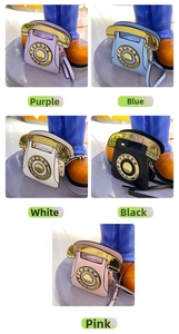 Close-up of retro phone shaped crossbody bag showing the creative dial pad and handset handle