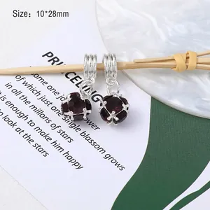 Detailed view of dark red faceted gemstone pendant in silver cage setting, size 10x28mm