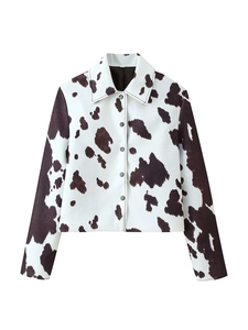 Close-up of woven texture and cow print pattern on a stylish lapel jacket