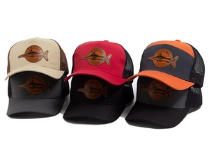 Close-up of mesh trucker hats with leather fishing patches in various colors
