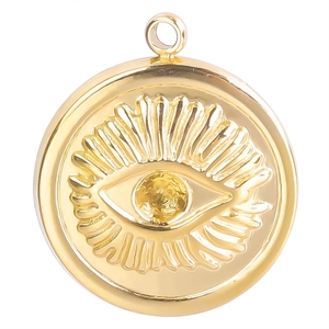Macro shot of gold stainless steel round charm with embossed evil eye and radial lines