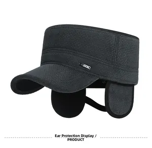 Close-up of winter flat top cap with foldable earflaps and thick grey waffle fabric