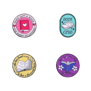 Set of four colorful enamel book pins with motivational reading quotes on white background