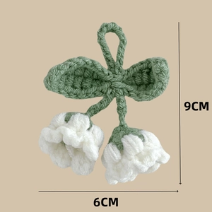 Detail view of handmade crochet lily of the valley keychain with 9cm height dimension