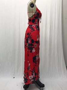 Detail view of red floral maxi dress with side split and lightweight chiffon texture