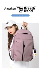 Detail of water-resistant oxford backpack in dusty pink with astronaut plush charm