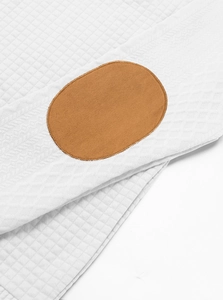 Detail of white waffle texture fabric with a brown suede elbow patch on men's jacket