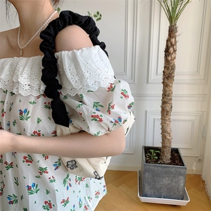 Detail of vintage textured canvas tote bag with butterfly embroidery and ruffled shoulder strap
