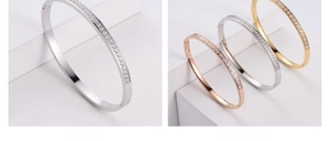 Close-up of three CNC rhinestone inlaid bangles in silver, rose gold, and gold finishes