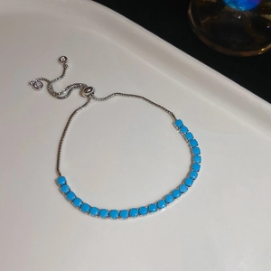 Macro shot of adjustable bolo bracelet featuring vibrant blue beads and silver accents