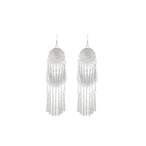 Detail of silver bohemian tassel earrings featuring round engraved bases and leaf charms