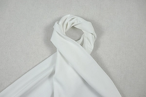 Detail of soft white chiffon fabric with elegant texture and translucent finish
