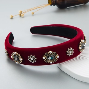 Detail of red velvet headband featuring grey crystals and pearls in vintage style