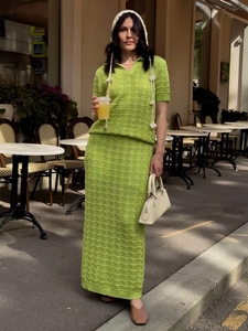Close-up of bright grass green hollow-out knit texture on a summer two-piece skirt set
