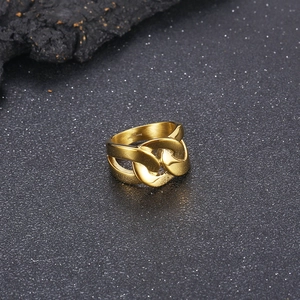 Macro view of gold stainless steel chain link ring detail showing high polish finish