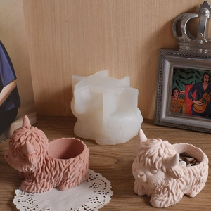 Scottish Highland cow silicone mold and finished plaster planters on wooden background