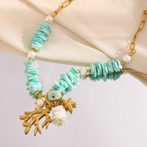 Close-up of 18K gold-plated necklace with turquoise, pearl, and coral starfish pendants