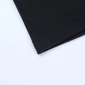 Detail of double-needle stitching and fine knit texture on a black mesh dress hem