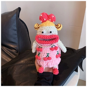 Detailed view of handmade pink crochet bag with big lips, cherry pattern, and pearl strap