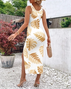 Detail of white bodycon maxi dress with gold leaf print and side slit for a vacation look
