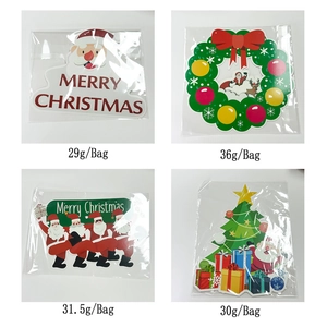 Detail view of four Christmas hanging signs including Santa Claus and Christmas tree themes