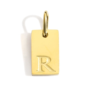 Macro shot of 18k gold plated rectangular pendant with engraved capital letter R