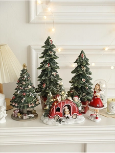 Cozy festive setup with resin Santa figurines and miniature trees on a white mantelpiece