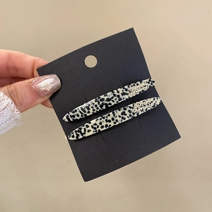 Detail of leopard print hair barrettes with gold Barrette La France lettering