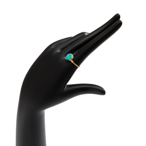 Detailed macro view of handmade gold wire-wrapped ring with turquoise gemstone