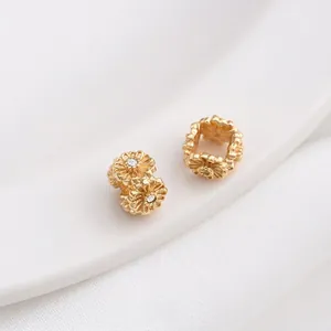 Macro view of 14K gold plated flower spacer bead with zircon inlay for DIY jewelry