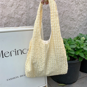 Close-up of the yellow checkered seersucker tote bag with unique bubble texture fabric