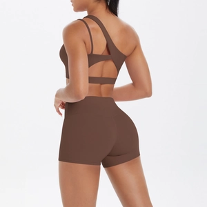 Rear view detail of brown one-shoulder sports bra and high-waist yoga shorts set