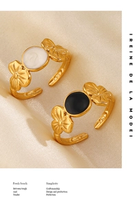Detail of 14K gold plated flower rings with black and white enamel flower petals