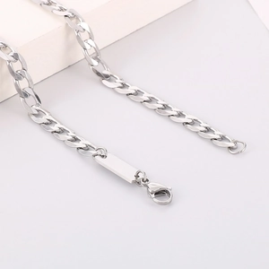 Detail of silver Cuban chain necklace with a small rectangular pendant and lobster clasp
