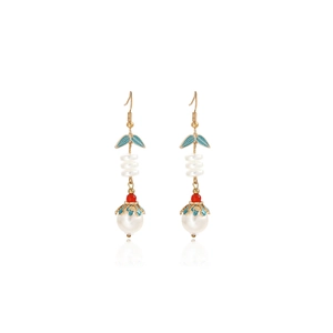 Detail of butterfly pearl tassel earrings with blue enamel leaves and red bead accents