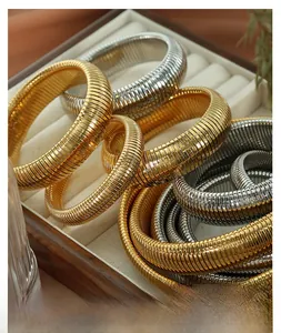 Detail of gold and silver Tubogas elastic metal bracelets in a jewelry box