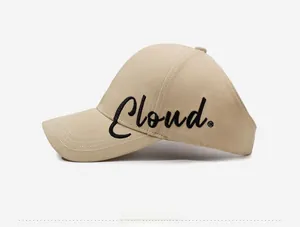 Close-up of beige sun visor cap with black Cloud embroidery and premium cotton texture