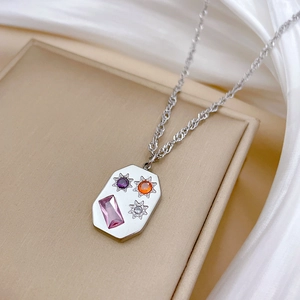 Detail of silver titanium necklace featuring an octagonal pendant with colorful crystals