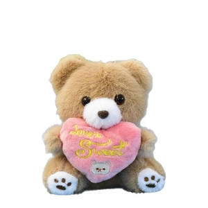 Cute brown plush teddy bear keychain holding a pink heart with Love is Sweet embroidery.