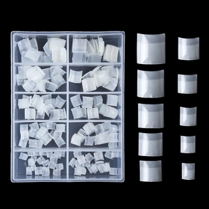 Close-up of 10 sizes French half-cover nail tips in a storage box on black background