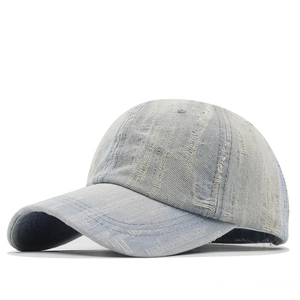 Distressed vintage light blue denim baseball cap with frayed texture and curved brim