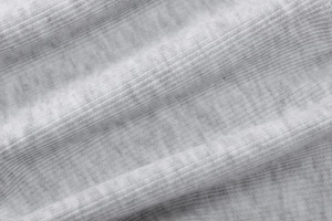Close-up of grey ribbed knit fabric texture showing high-quality soft material detail