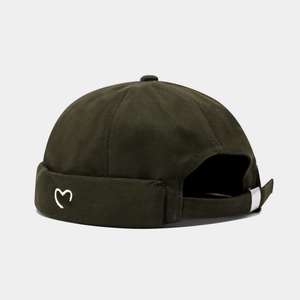Detail of dark olive miki hat featuring heart embroidery and adjustable metal buckle