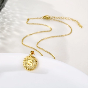 Detail of golden S letter pendant with beaded edge and adjustable O-chain necklace