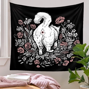 Detail of wall tapestry featuring a white cat and pink flowers on black fabric