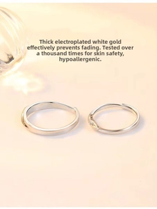 Detail of silver Cupid Feather couple rings with platinum plating and adjustable bands
