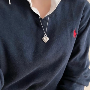 Close-up of 925 sterling silver heart pendant necklace with textured caviar finish