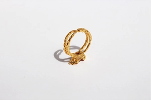 Detail shot of golden double-layered adjustable ring featuring irregular textured metal surface